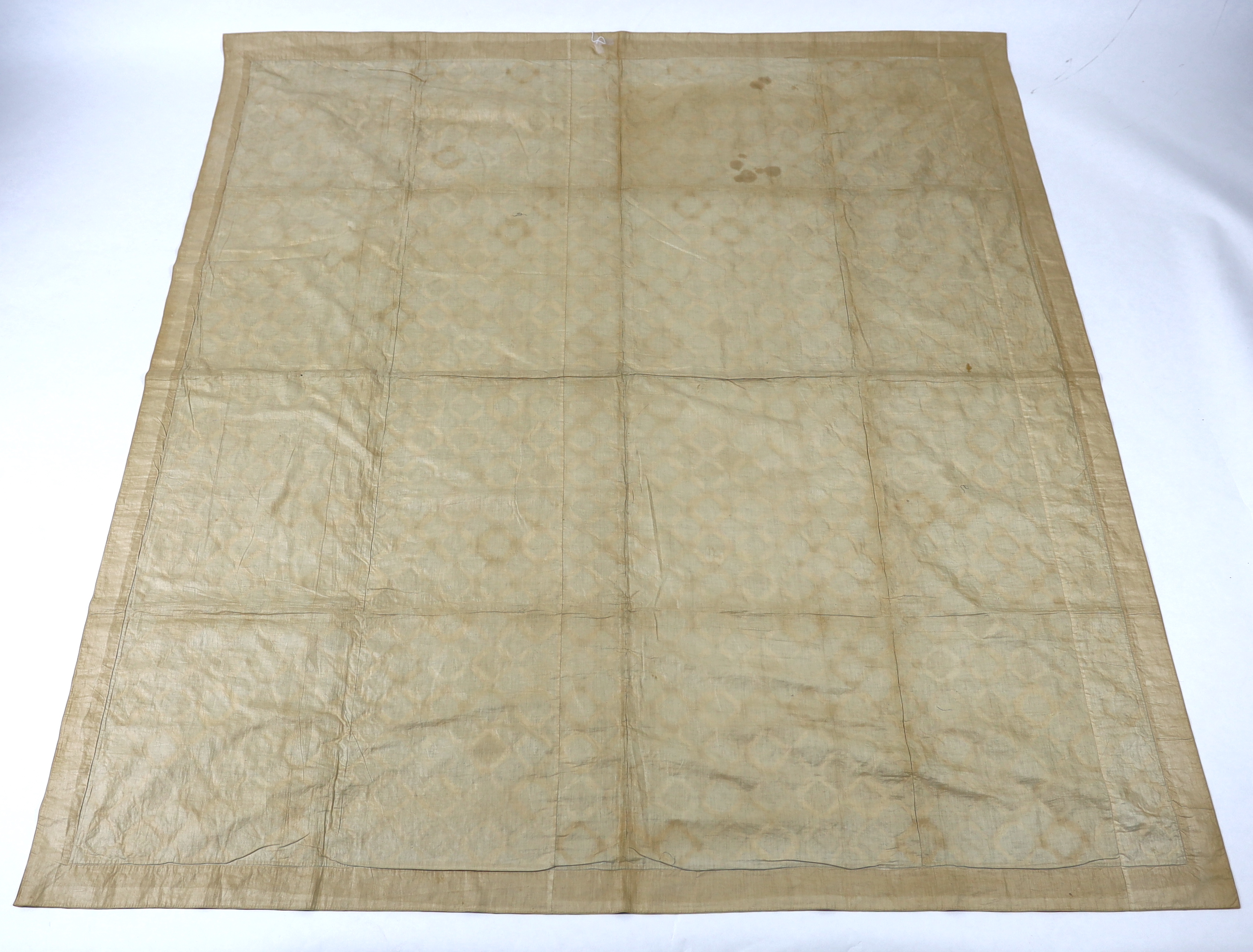 A handsome 19th century silk patch worked quilt, worked in repeating octagon shapes, in a large selection of 19th century printed and woven brocaded silks on a black and brown velvet background, edged with a 19th century